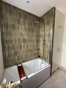 Bathroom refit with olive zellige wall tiles, rain shower and freestanding bath in South London