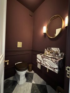 Luxury cloakroom renovation with marble basin, brass wall taps and checkerboard floor in South London period property